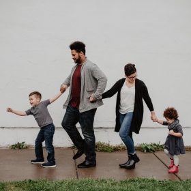 family-of-four-walking-at-the-street-2253879